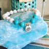 Bracelet 8mm magnesite/howlite with lotus charm